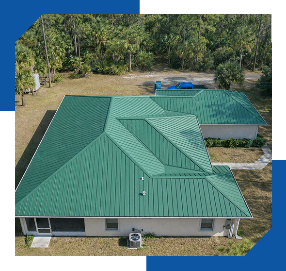 Green standing-seam metal roof on a single-story home, aerial view