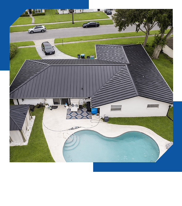 Aerial view of a dark gray metal roof on a home with a backyard pool