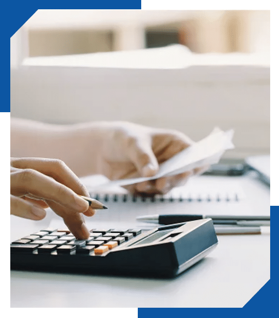 Hands using a calculator and holding a receipt while reviewing roofing costs