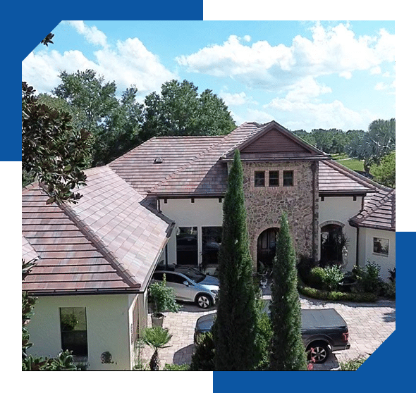 Two-story home with a stone entry tower and a new terracotta-blend tile roof