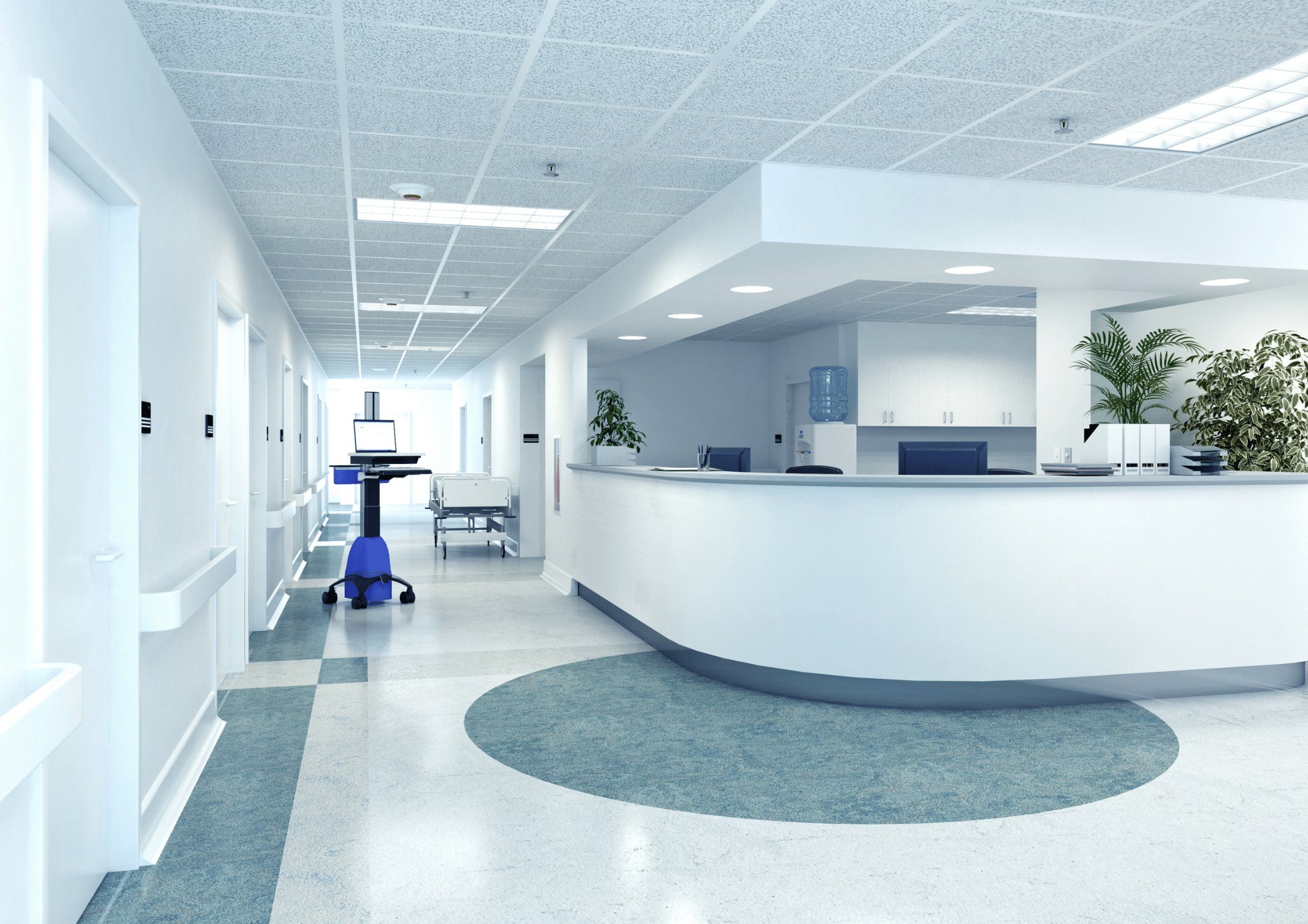 Bright hospital hallway with a nurses' station and patient bed