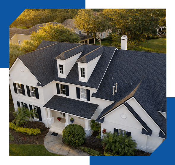 Aerial view of a white two-story home with a dark gray architectural shingle roof