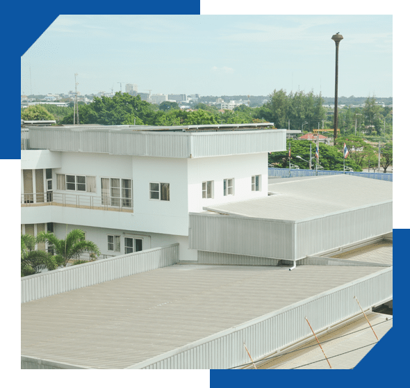Low-slope metal roofs on a white multi-level commercial building