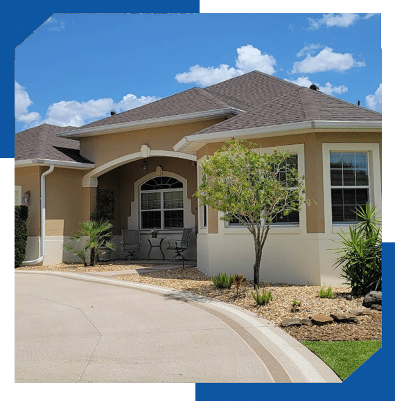 Single-story stucco home with a gray architectural shingle roof and arched front entry