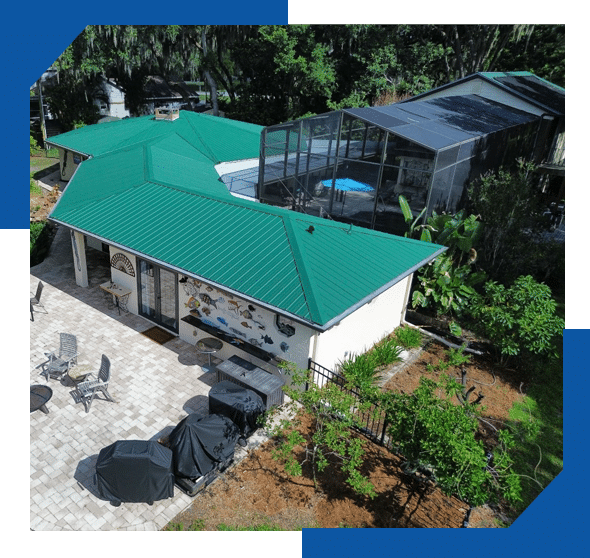 Green standing seam metal roof on a pool house beside a screened pool enclosure and paver patio