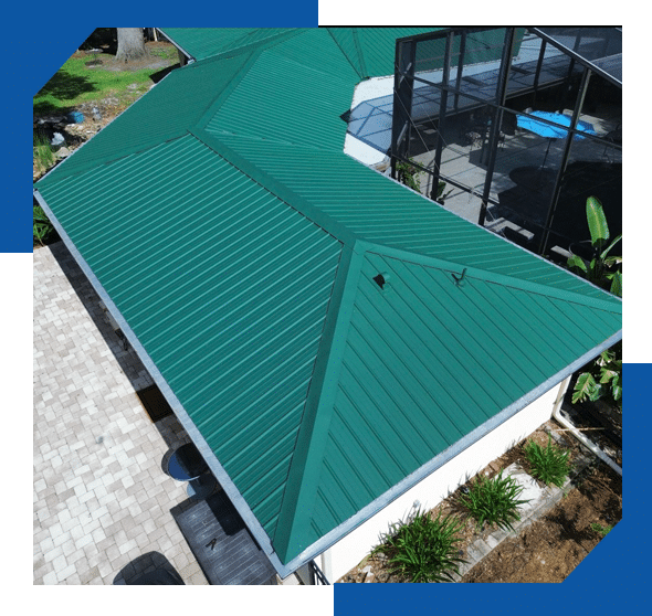 Close-up of a green standing seam metal hip roof next to a screened pool enclosure