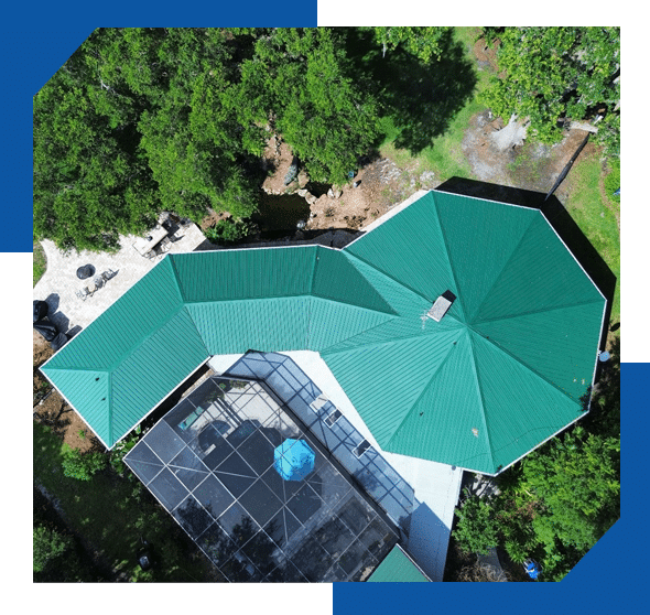 Overhead drone view of a home with a green metal roof, including an octagonal section, beside a screened pool