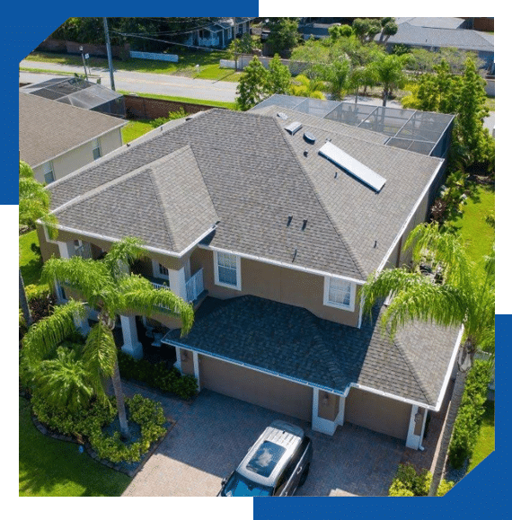 Aerial view of a two-story stucco home with a new gray architectural shingle roof and palm trees