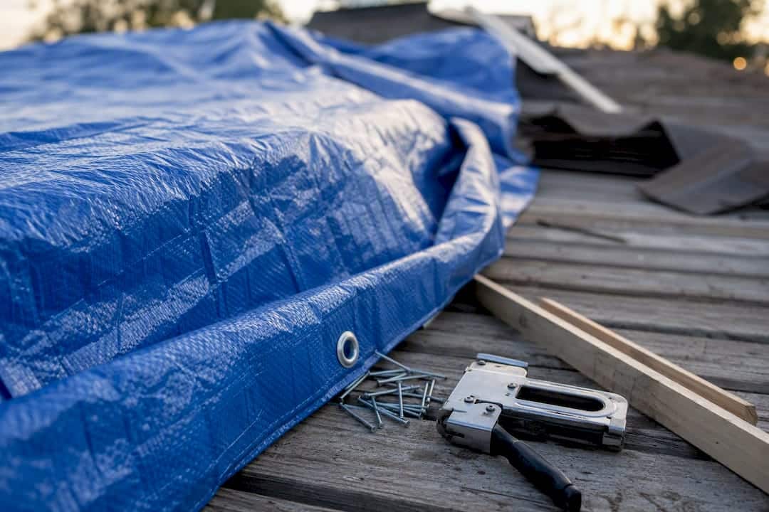 Close-up of roofing tarp and fastening tools